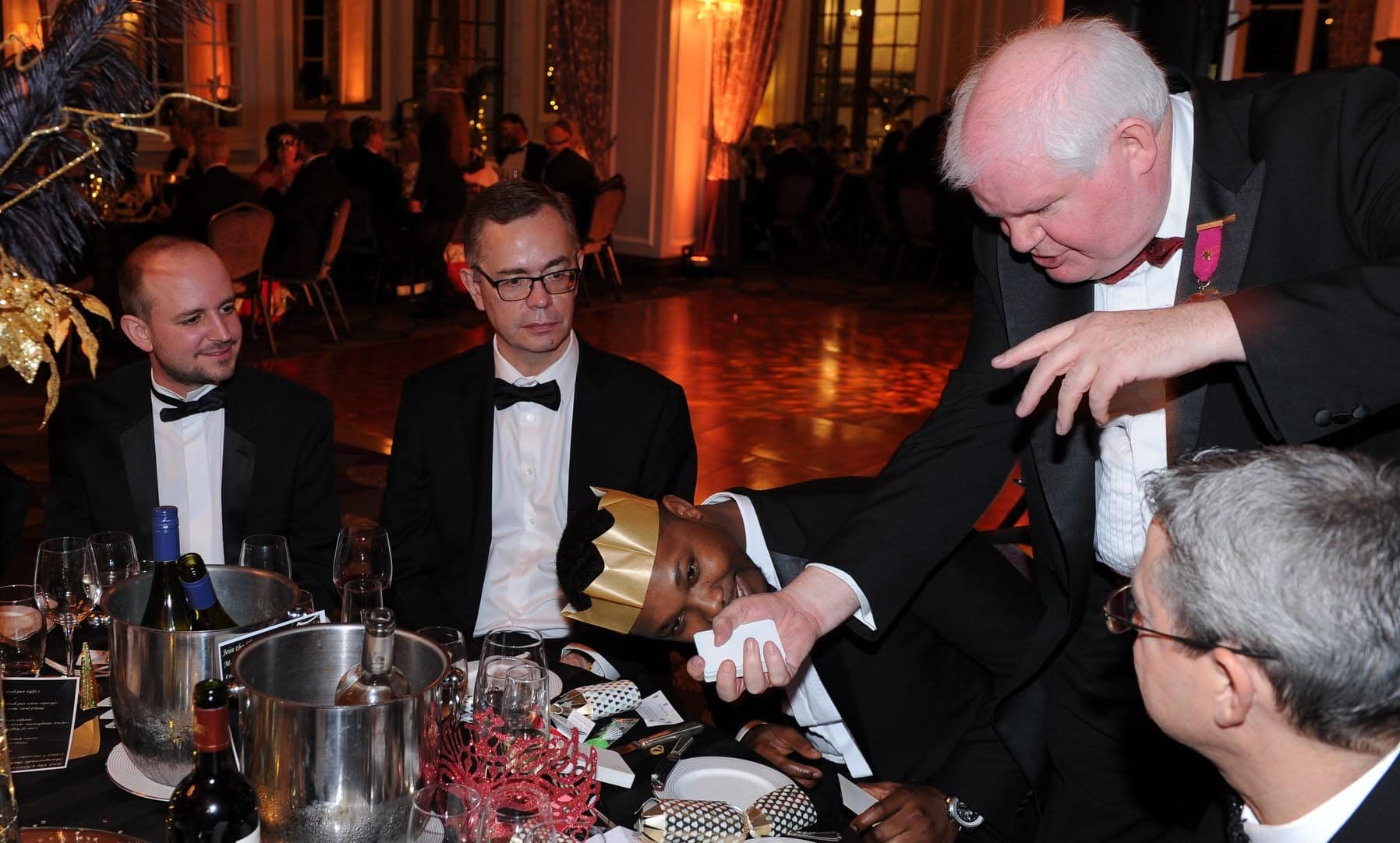 James entertaining at a table